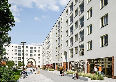 ein weißes Gebäude mit viele Fenstern und Gewerbeeinheiten im Erdgeschoss