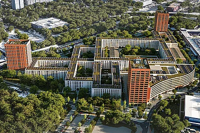 Luftbildansicht des KONNEKT-Quartiers mit Gebäuden mit Gründächern, zwei Terrakotta-Hochhäusern und viel Baumbestand.