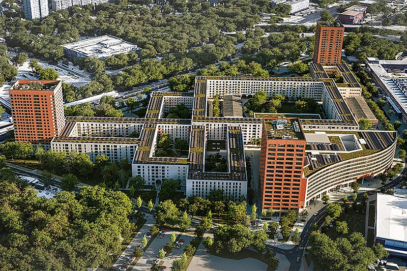 Luftbildansicht des KONNEKT-Quartiers mit Gebäuden mit Gründächern, zwei Terrakotta-Hochhäusern und viel Baumbestand.