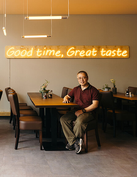Restaurant owner sitting at a table.