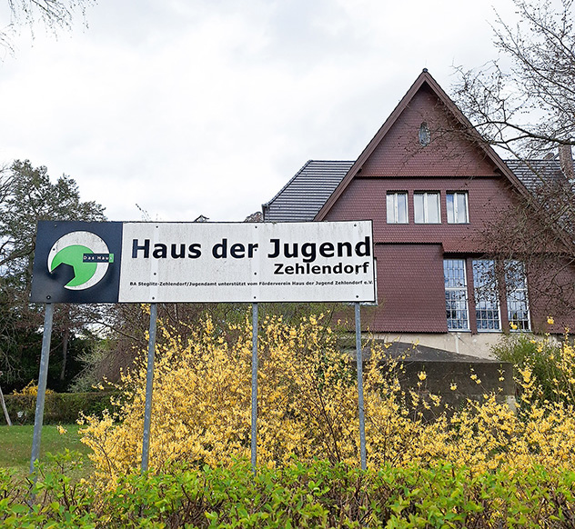Old pitched roof house with a sign in front that says "House of Youth" 